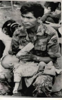 An RVN soldier feeding a baby